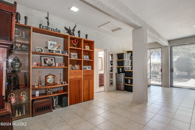 interior space with a textured ceiling and light tile patterned floors