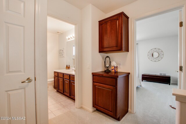 hall with light carpet and sink