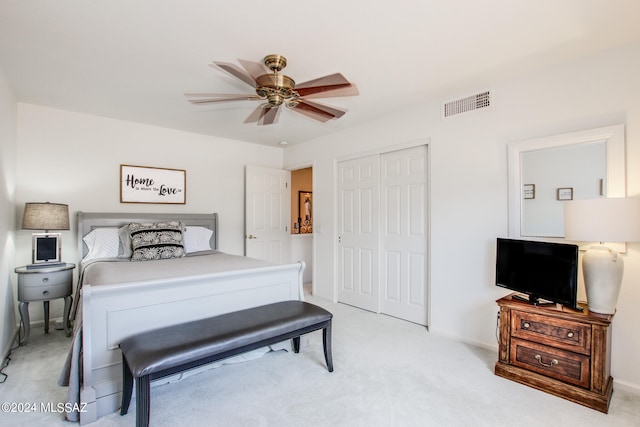 carpeted bedroom featuring a closet and ceiling fan