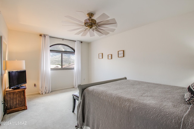 bedroom featuring light colored carpet and ceiling fan