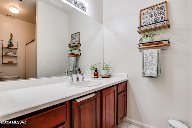 bathroom featuring toilet and vanity