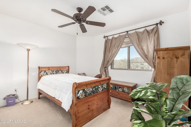 carpeted bedroom featuring visible vents and ceiling fan