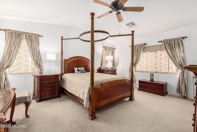 carpeted bedroom featuring visible vents and ceiling fan