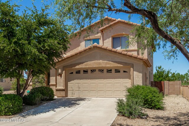 mediterranean / spanish home with a garage