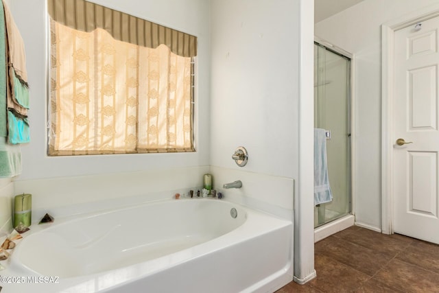 bathroom with a stall shower and a bath