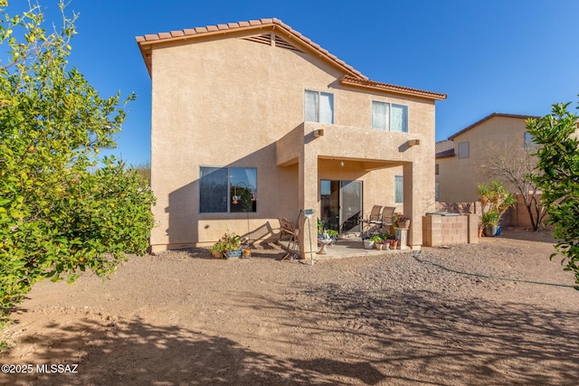 back of house featuring stucco siding and a patio