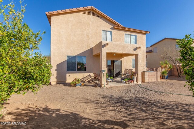 rear view of property with a patio area