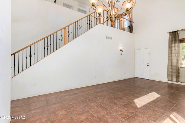 17616 S Vermillion Sunset Dr, Vail, AZ 85641 - unfurnished living room featuring a high ceiling, a chandelier, baseboards, and stairs