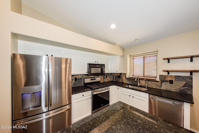 kitchen with white cabinets, lofted ceiling, and appliances with stainless steel finishes