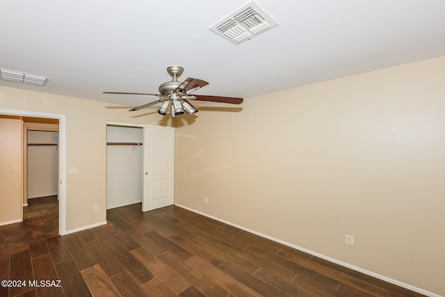 unfurnished bedroom with ceiling fan and dark hardwood / wood-style flooring