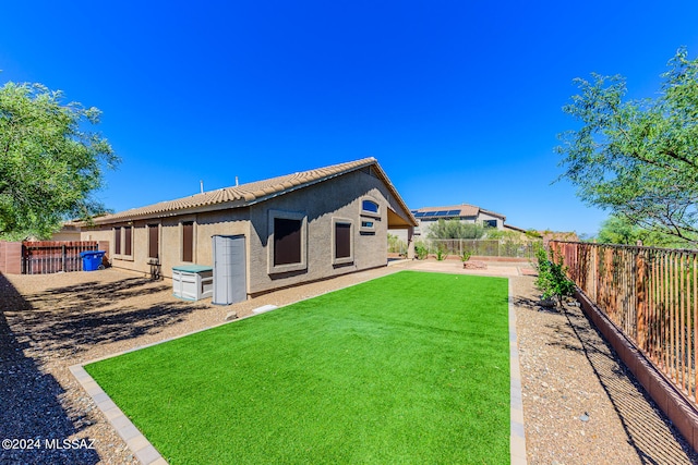 rear view of property with a lawn and a patio area