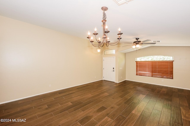 empty room with ceiling fan with notable chandelier, lofted ceiling, and dark wood-type flooring