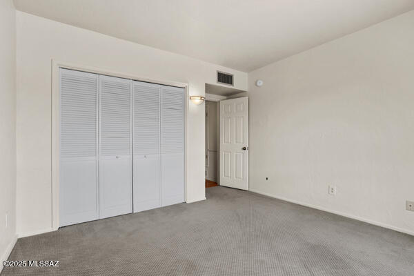 unfurnished bedroom featuring a closet and carpet flooring