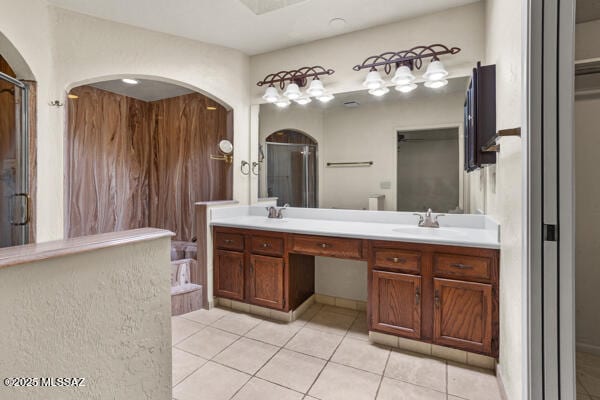 bathroom featuring walk in shower, vanity, and tile patterned flooring