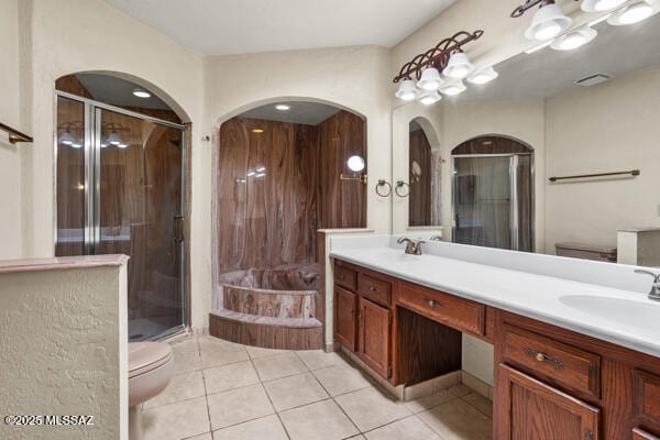 full bathroom with vanity, shower with separate bathtub, tile patterned floors, and toilet