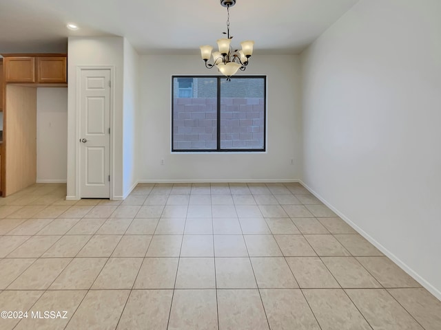 tiled empty room with a notable chandelier