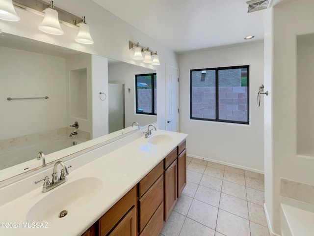 bathroom with tile patterned flooring, a washtub, and dual vanity