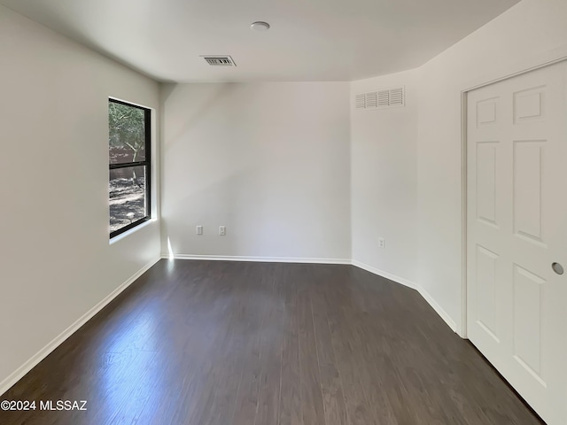 unfurnished room featuring dark hardwood / wood-style flooring