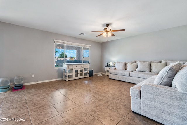 living room featuring ceiling fan and tile patterned floors