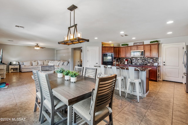 dining area with ceiling fan and light tile patterned floors