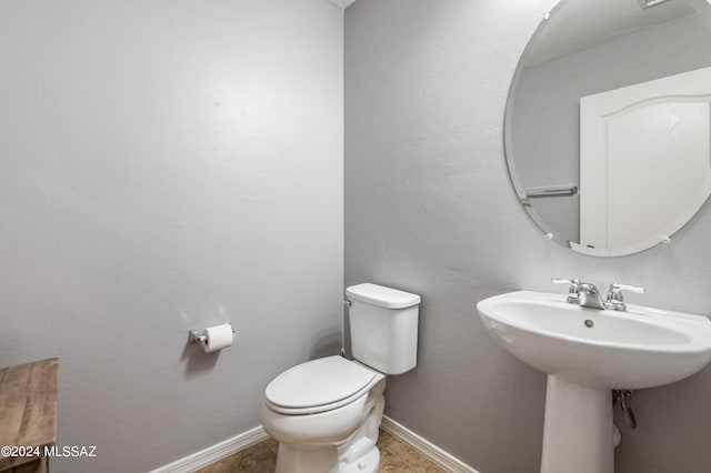 bathroom with tile patterned floors and toilet