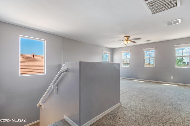 hallway featuring light colored carpet