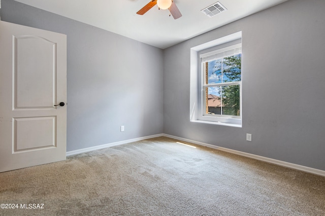 carpeted empty room featuring ceiling fan