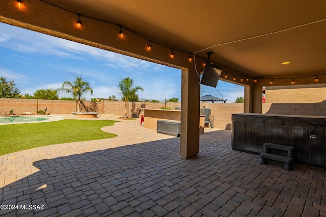 view of patio featuring a pool with hot tub