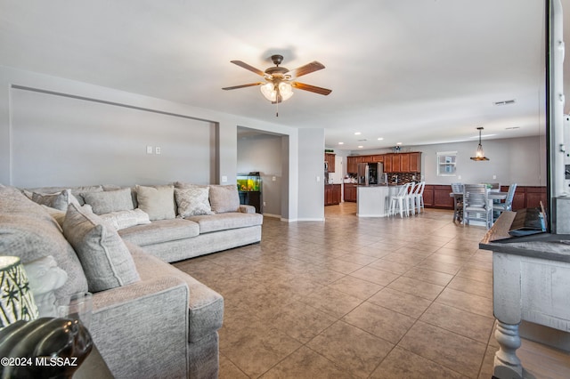 living room featuring ceiling fan and light tile patterned flooring