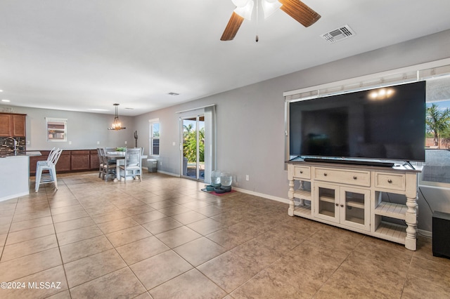 tiled living room featuring sink and ceiling fan