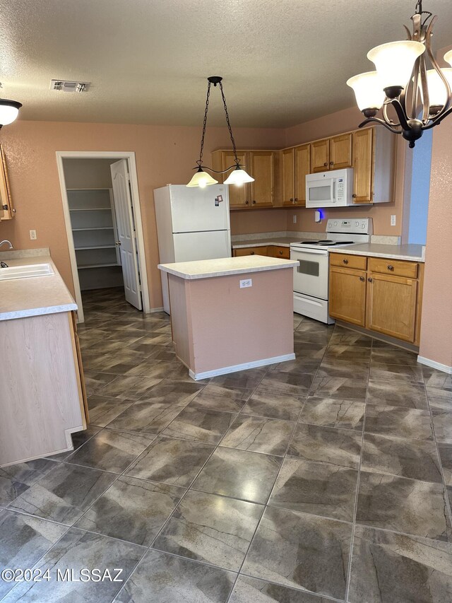 kitchen with white appliances, sink, a textured ceiling, decorative light fixtures, and a chandelier