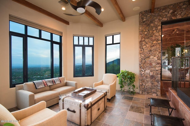 living room featuring ceiling fan, a mountain view, and beam ceiling