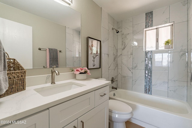 full bathroom with toilet, tiled shower / bath combo, and vanity