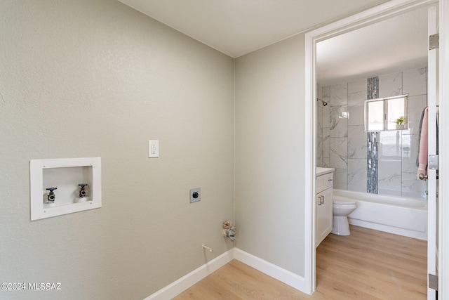 laundry area featuring hookup for an electric dryer, light wood-type flooring, and washer hookup