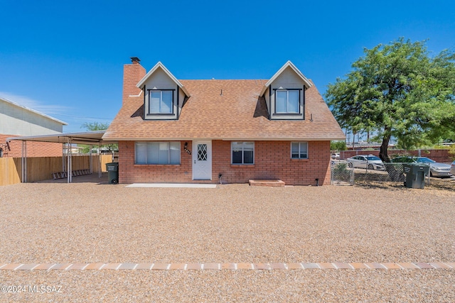 back of house featuring a carport