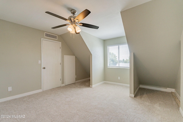 bonus room with ceiling fan, light carpet, and lofted ceiling