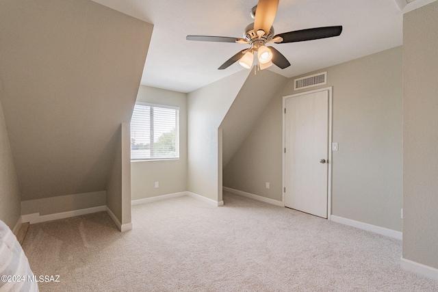 bonus room with ceiling fan, vaulted ceiling, and light colored carpet