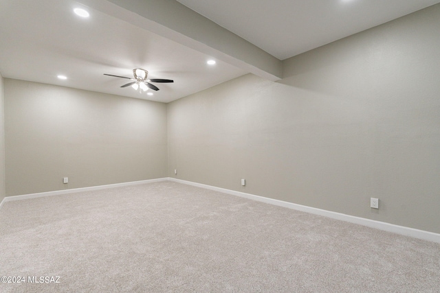 empty room with carpet floors, ceiling fan, and beam ceiling