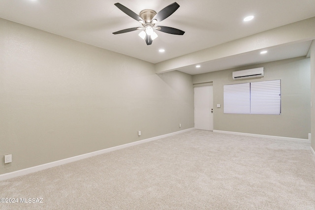 spare room with ceiling fan, carpet flooring, and an AC wall unit