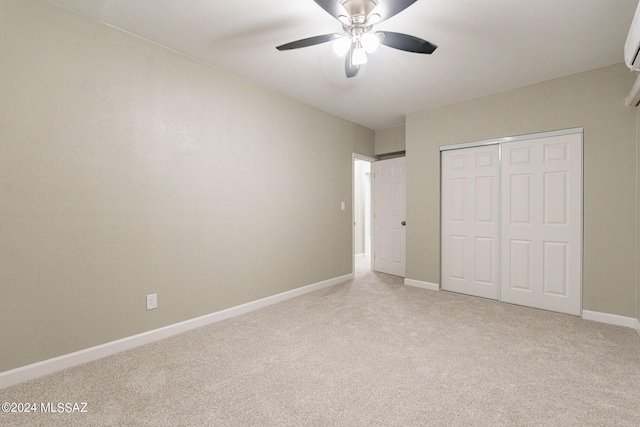 unfurnished bedroom with a closet, ceiling fan, and light carpet