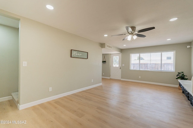 unfurnished room with ceiling fan and light hardwood / wood-style floors