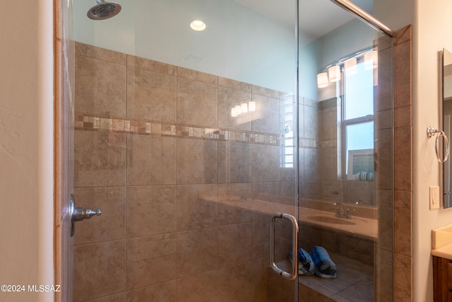 bathroom with vanity and a shower with door