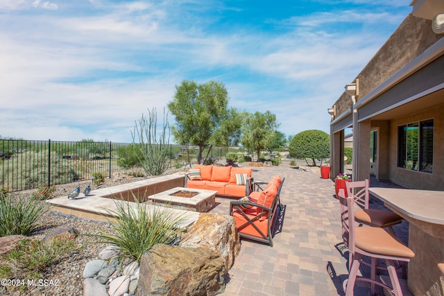 view of patio featuring an outdoor living space with a fire pit