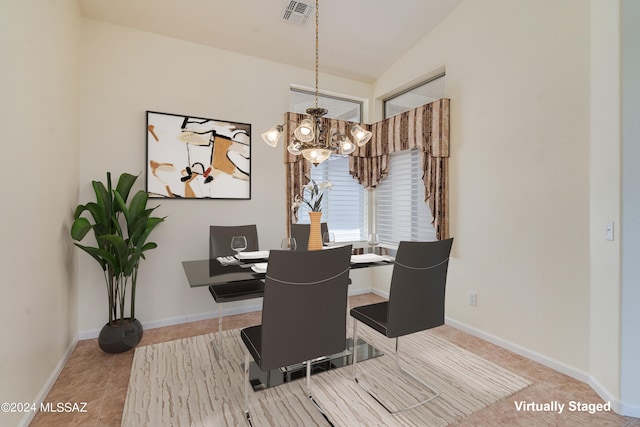 tiled dining space featuring a chandelier, lofted ceiling, visible vents, and baseboards