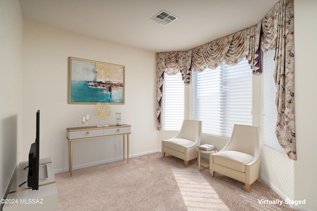 sitting room featuring carpet flooring, visible vents, and baseboards