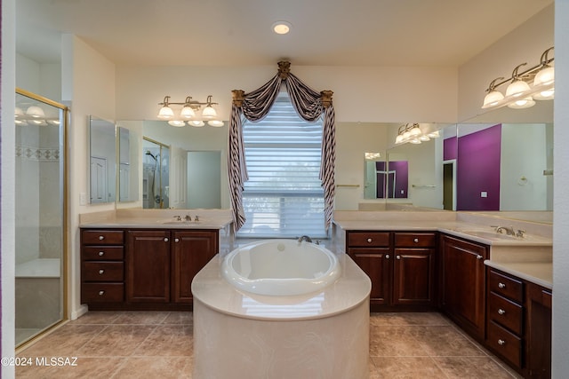 full bathroom with a garden tub, tile patterned flooring, two vanities, a sink, and a shower stall