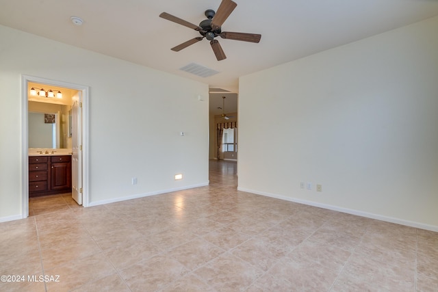 spare room featuring ceiling fan, light tile patterned flooring, visible vents, and baseboards