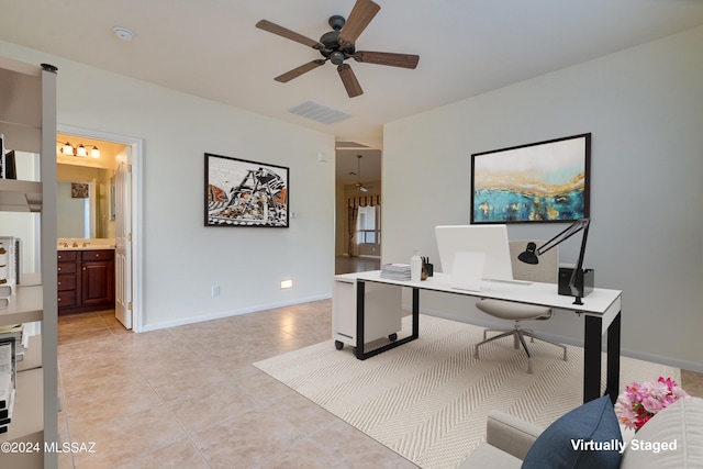 office featuring ceiling fan, visible vents, baseboards, and light tile patterned flooring