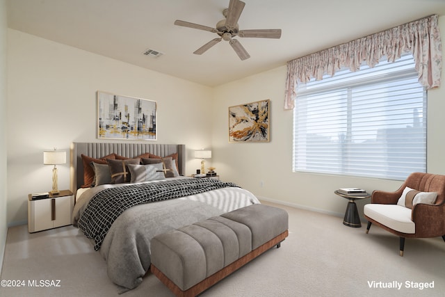 bedroom with a ceiling fan, carpet flooring, visible vents, and baseboards