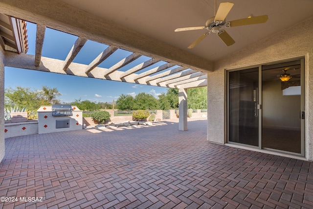 view of patio / terrace featuring an outdoor kitchen, a ceiling fan, a grill, fence, and a pergola